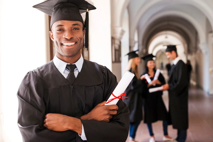 college graduate holding his diploma | Romain Subaru in Evansville IN