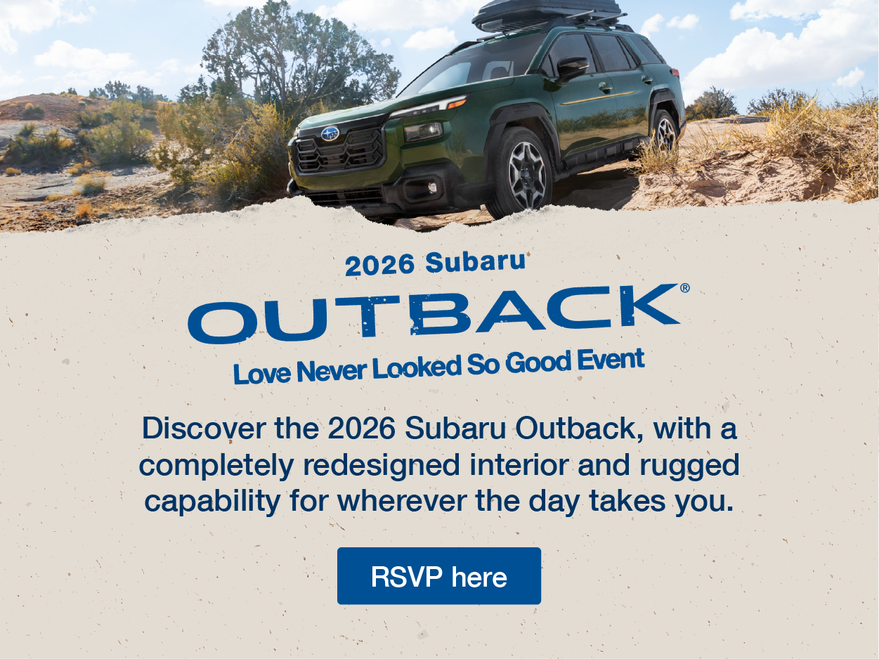 Subaru Outback driving on rugged terrain.